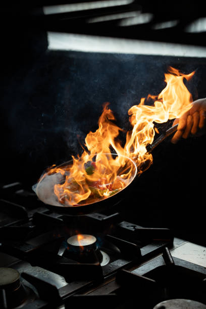 istock Chef Managing Flames in Wok Cooking 2201536587
