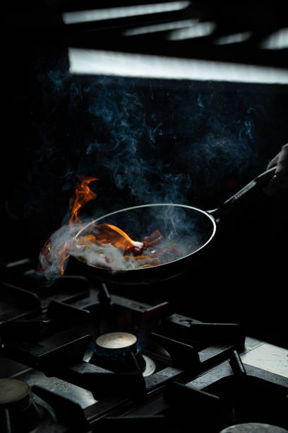 istock Chef Handling Flaming Wok in Kitchen 2201536615