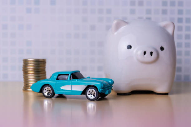 istock Coin pile, piggy bank and a car. 2201536620