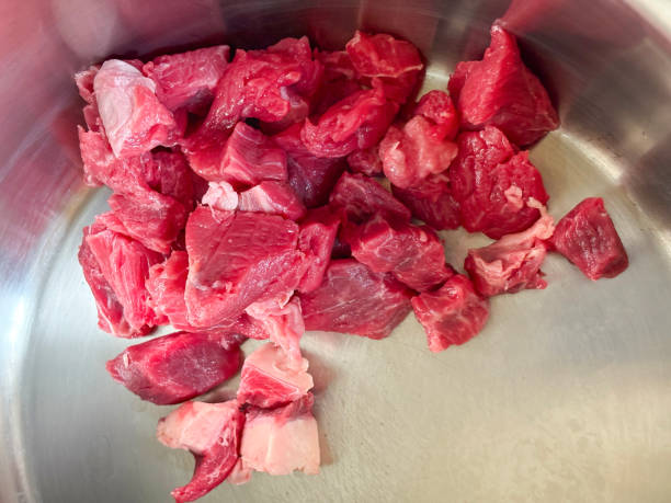 istock Beef cubes in a cooking pan. Meat slices in a saucepan 2201539810
