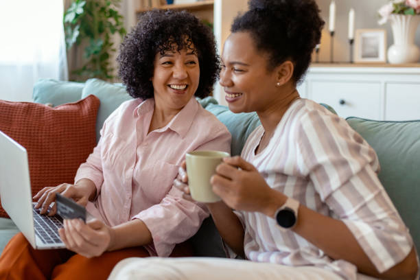 istock Joyful Friends Browsing Online Deals on a Laptop 2201542249