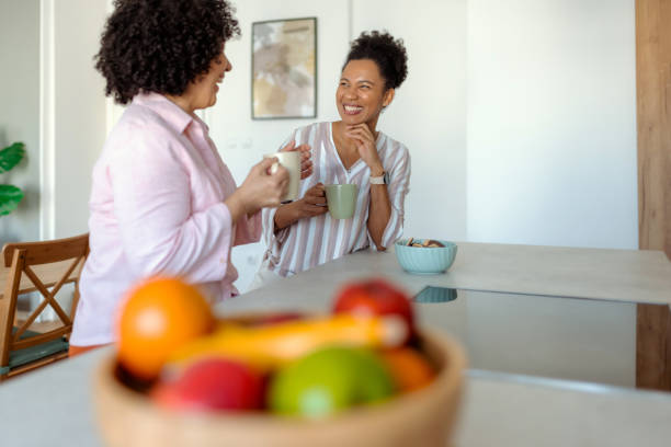 istock Heartwarming Kitchen Moments: Two Women Sharing Coffee and Stories 2201542251