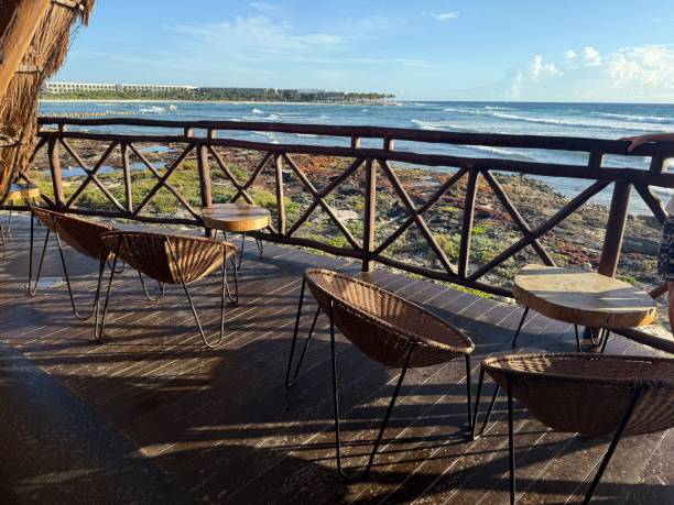 istock Modern, luxury boho. Oceanfront chill spot with ample seating for entertaining on a veranda of an enclosed pergola.  Wooden patio. 2201542450
