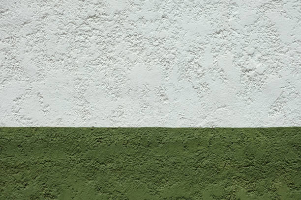 Double colored grunge wall with slightly rough texture, divided in two parts. Wall painted in two colors, white and green.