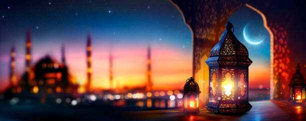 istock Ramadan Kareem - Arabic Lantern With Crescent Moon - Defocused Mosque On Background At Sunset With Bokeh Lights 2201545445