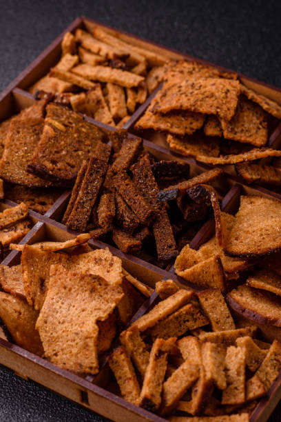 istock Crispy homemade brown bread chips with seeds and grains 2201545755