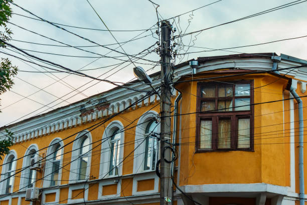 Lots of electrical wires and internet cables (Optical fiber) on a pole above the street - a problem in many cities. Electric power transmission and Electricity supply in city