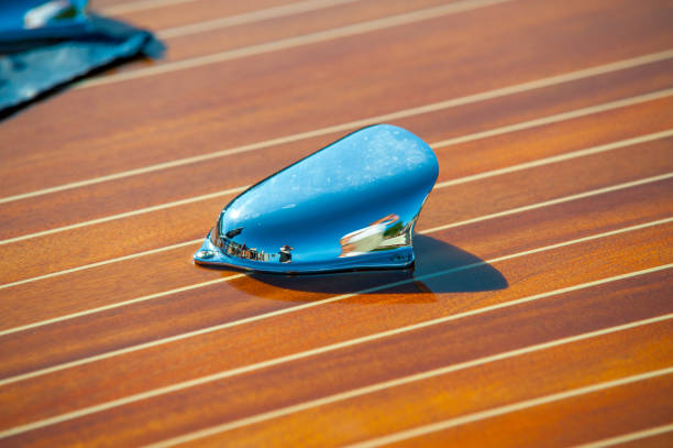 chrome vent on polished wooden boat deck reflecting surroundings..