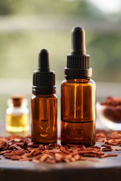 istock Two bottles of aromatherapy essential oil with red sandalwood 2201548971