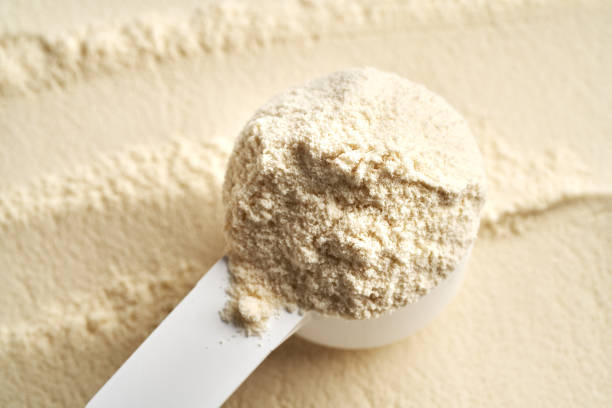 istock Whey protein powder in a measuring spoon, closeup 2201549182