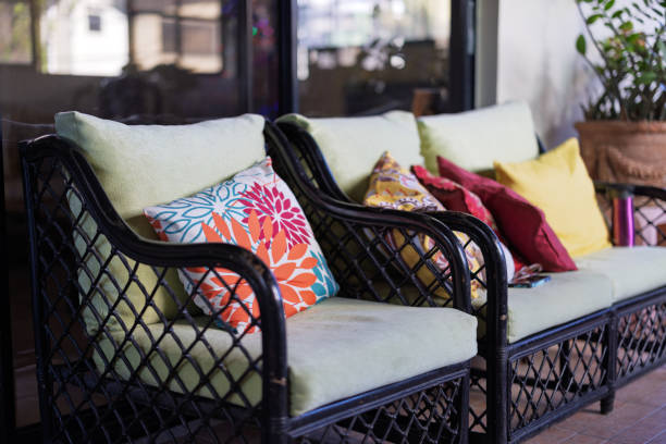 Outdoor old chairs with colorful cushions in a porch or deck