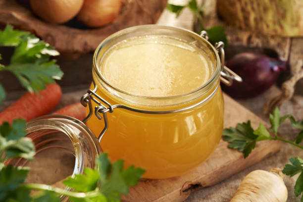 istock Bone broth in a glass jar with fresh vegetables 2201549231