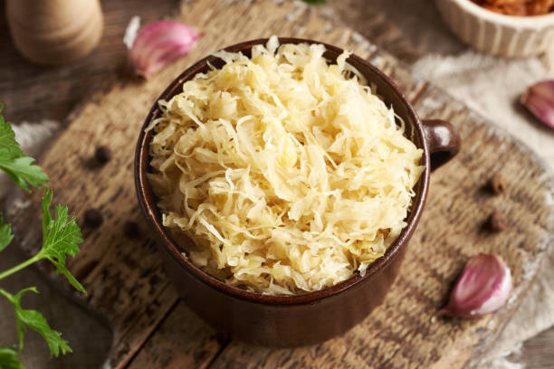 istock Fermented white cabbage or sauerkraut in a brown pot 2201551249