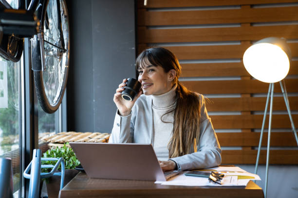 istock Woman works from cozy cafe 2201551677
