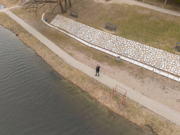 Adult man enjoy walking by the lake in public park
