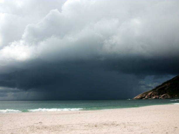istock A heavy rainstorm coming on a desert beach with white sand portraiting a molehill 2201552697