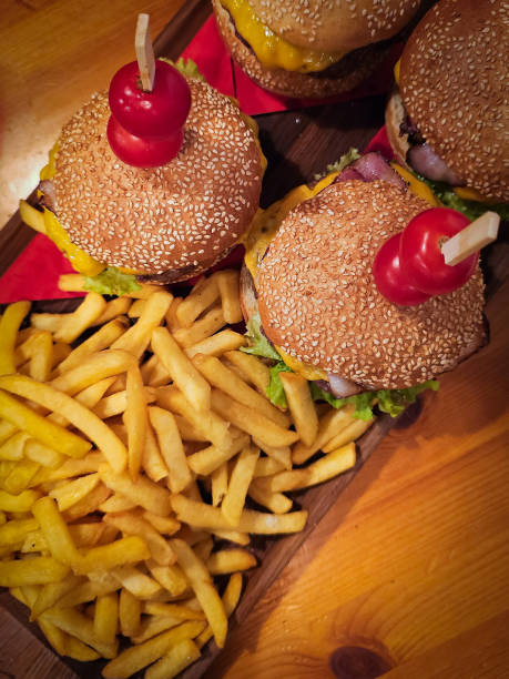 istock Delicious cheeseburgers served with crispy fries in a cozy restaurant setting 2201553855