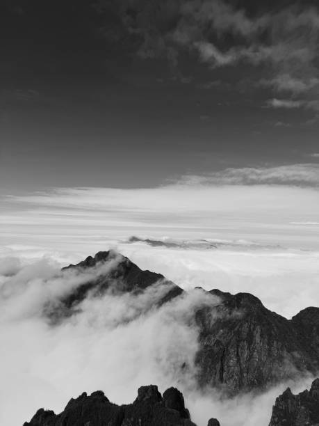 istock Monochrome Mountain Silhouette Above the Clouds 2201554047