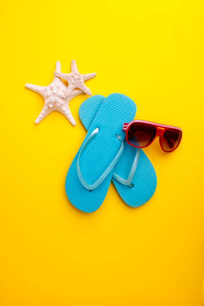 Flip flops with Thai flag on the beach. Thailand resorts, vacation, tours, travel packages concept. 3D rendering