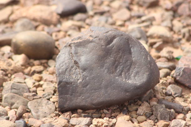 istock A close-up of a black stone on the ground 2201571604