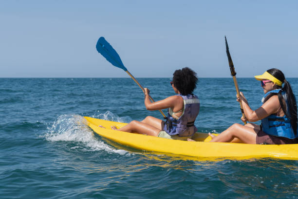 istock Two women kayaking in the ocean on a sunny day 2201572062
