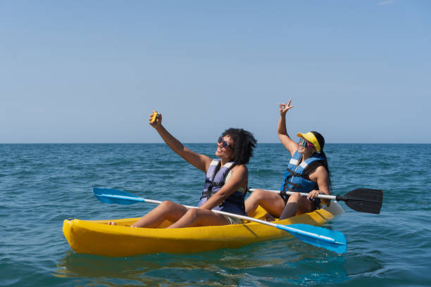istock Two happy women kayaking and taking selfie on summer vacation 2201572090