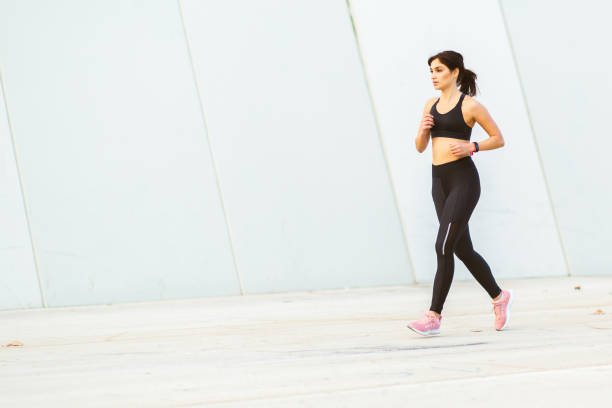istock Female runner in sportswear doing running workout outside 2201572272