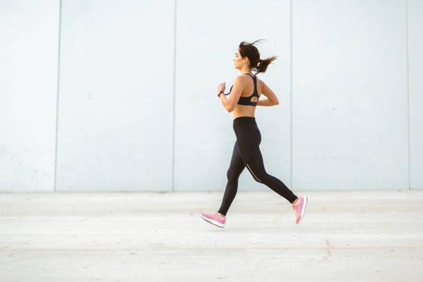 istock Sportswoman jogging outdoors in morning 2201572294