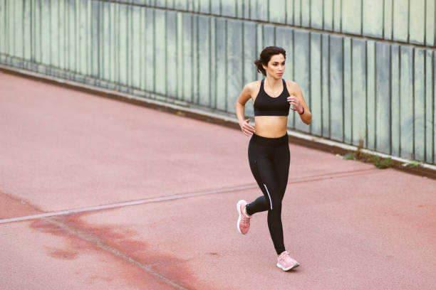 istock Young female runner doing running workout outdoors 2201572353