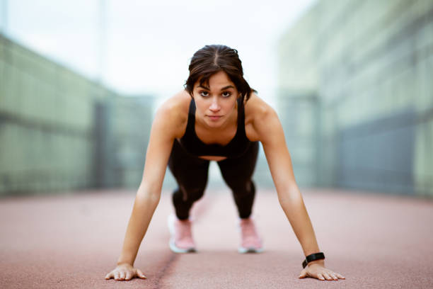 istock Healthy young woman doing push ups 2201572358