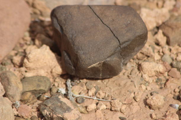 istock A close-up of a black stone on the ground 2201574480