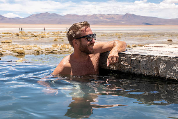 istock Man Relaxing in Outdoor Hot Spring 2201575036