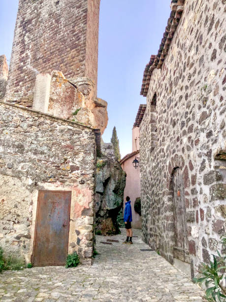 istock Young man explores rural village streets 2201575302