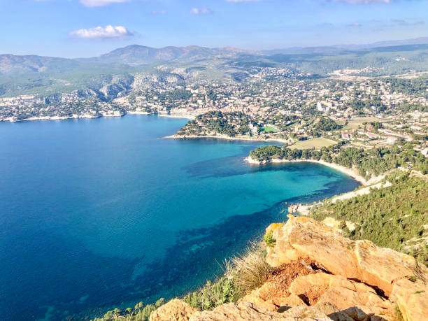 Elevated view of calm bay, hills and villages, Provence