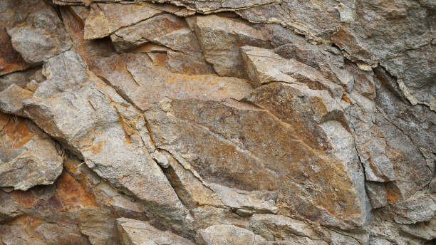 istock Light brown orange rusty beige gray white stone rock granite background. Mountain surface texture. Close-up. For design. 2201581757