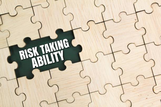 istock wooden puzzle and the word risk taking ability. ability to take risks 2201590067