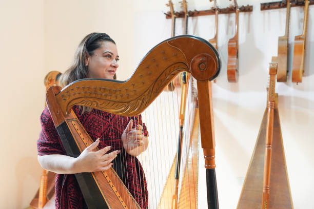 istock Latin music teacher playing a Paraguayan harp in her workshop 2201592428
