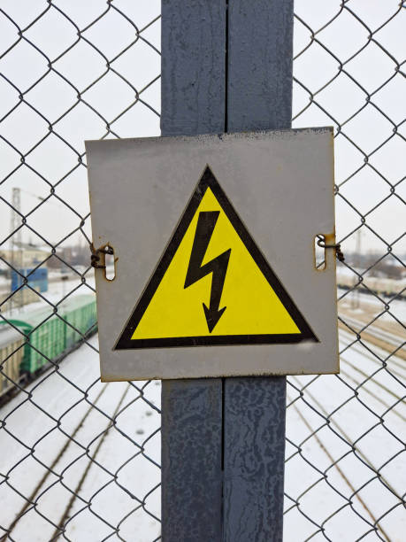 istock Sign - Caution electric voltage. Black lightning in the yellow triangle 2201593843