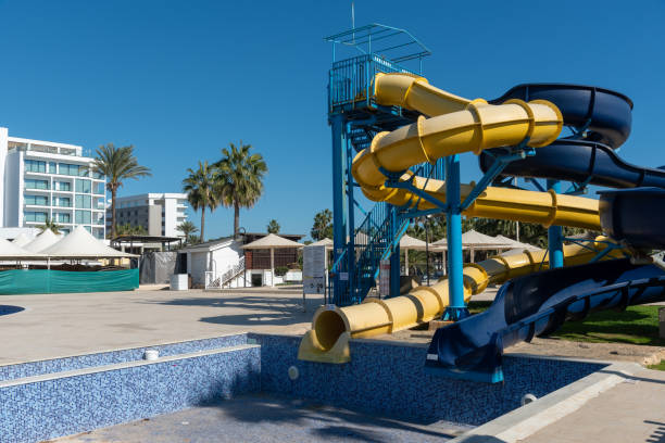 istock Colorful waterslides dominating empty water park under blue sky 2201594578