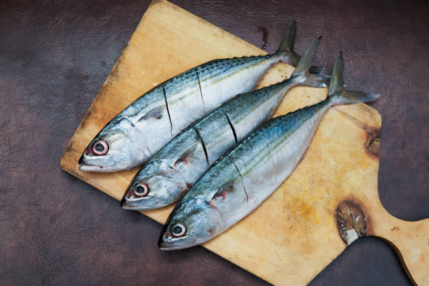 istock Fresh Mackerel Fish On Wooden Chopping Board 2201594597