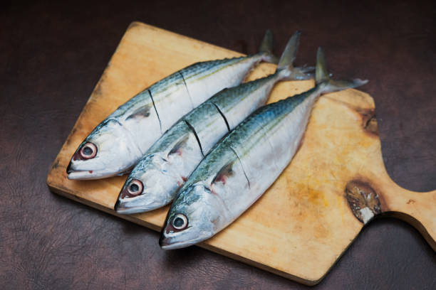 istock Fresh Mackerel Fish On Wooden Chopping Board 2201594621