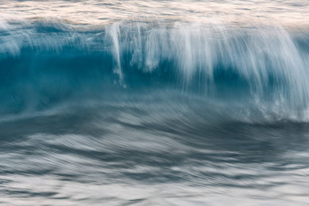 istock A long exposure Photograph of a wave in motion creating a blurred abstract image. 2201595748