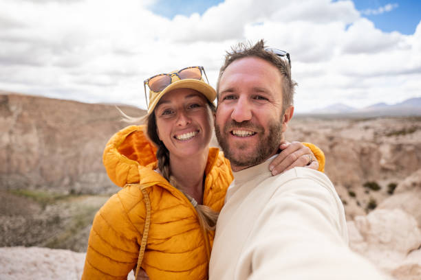 istock Smiling Couple Taking a Selfie at a Scenic Canyon 2201596608
