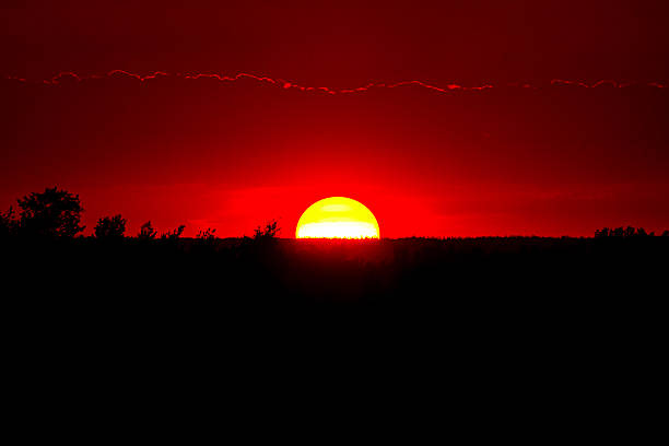 istock Spectacular sunset with big round sun and red sky. 2201597840