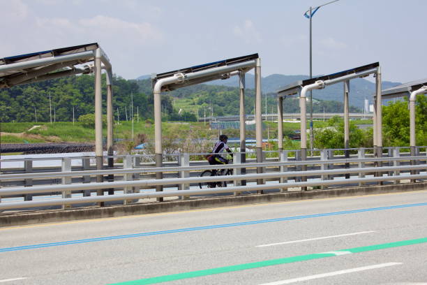 Sejong City, South Korea - May 26, 2021: A cyclist rides along the solar-covered bike path on North Star Road. This dedicated lane provides a shaded, eco-friendly route for commuters and recreational cyclists.