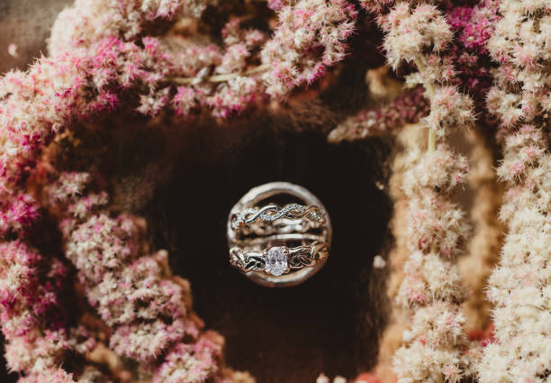 istock Wedding rings with pink dried flower background 2201600152