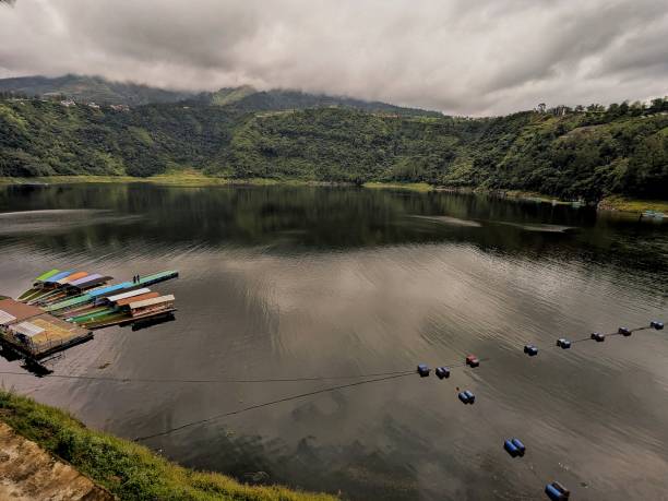 istock a cloudy atmosphere in the lake with several ships bowed. The location at Telaga Menjer Wonosobo, Indonesia 2201600332