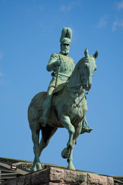 King Philip IV equestrian statue rising against a dramatic cloudy sky in Plaza de Oriente, central Madrid, Spain, embodying history and Spanish heritage