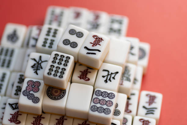 istock Mahjong tiles stacked on a red background 2201611276