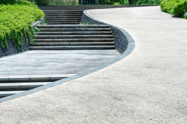 istock Curved pathway and stairs through the lush green park 2201612922